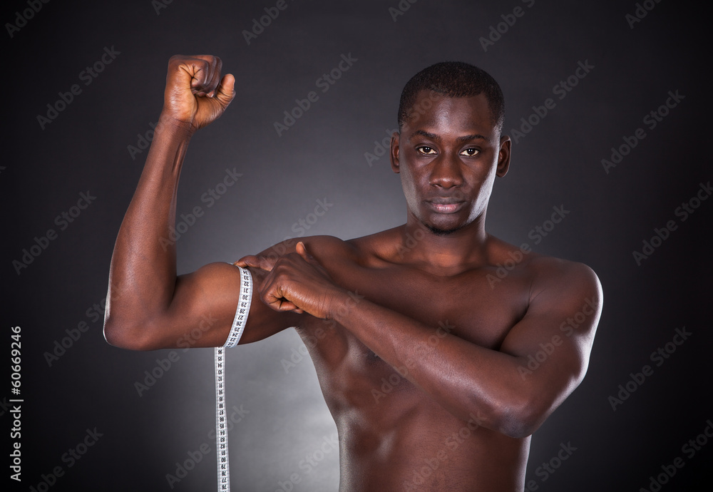 Man Measuring His Biceps